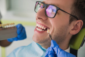 dental implants services, man receiving tooth implants