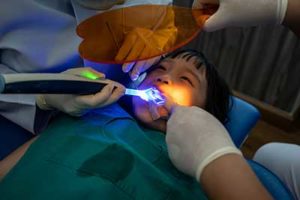 fluoride treatments tx, child in dental chair during procedure