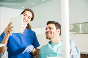 specialty dental services pearland tx, dentist and patient looking at tablet