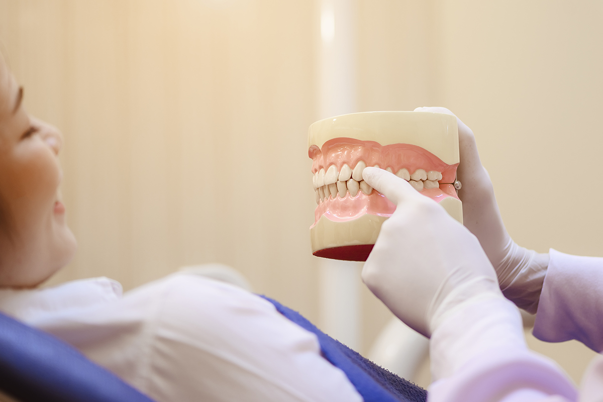 a dentist explaining causes of receding gums