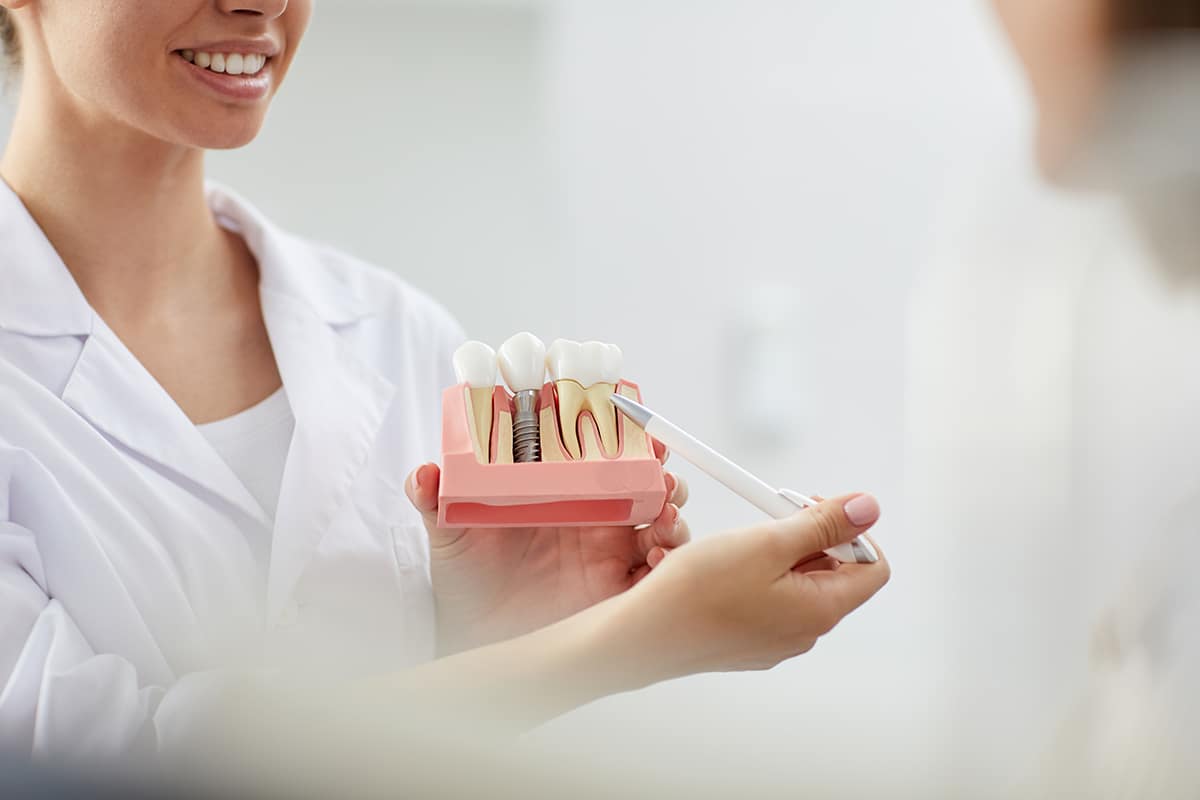 a dentist explaining to her patient endosteal implants