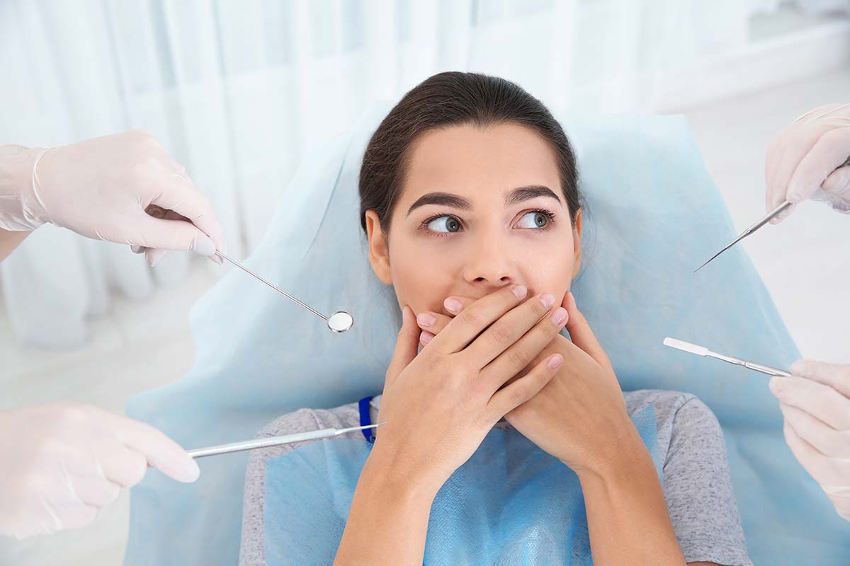 a woman struggling with dental anxiety