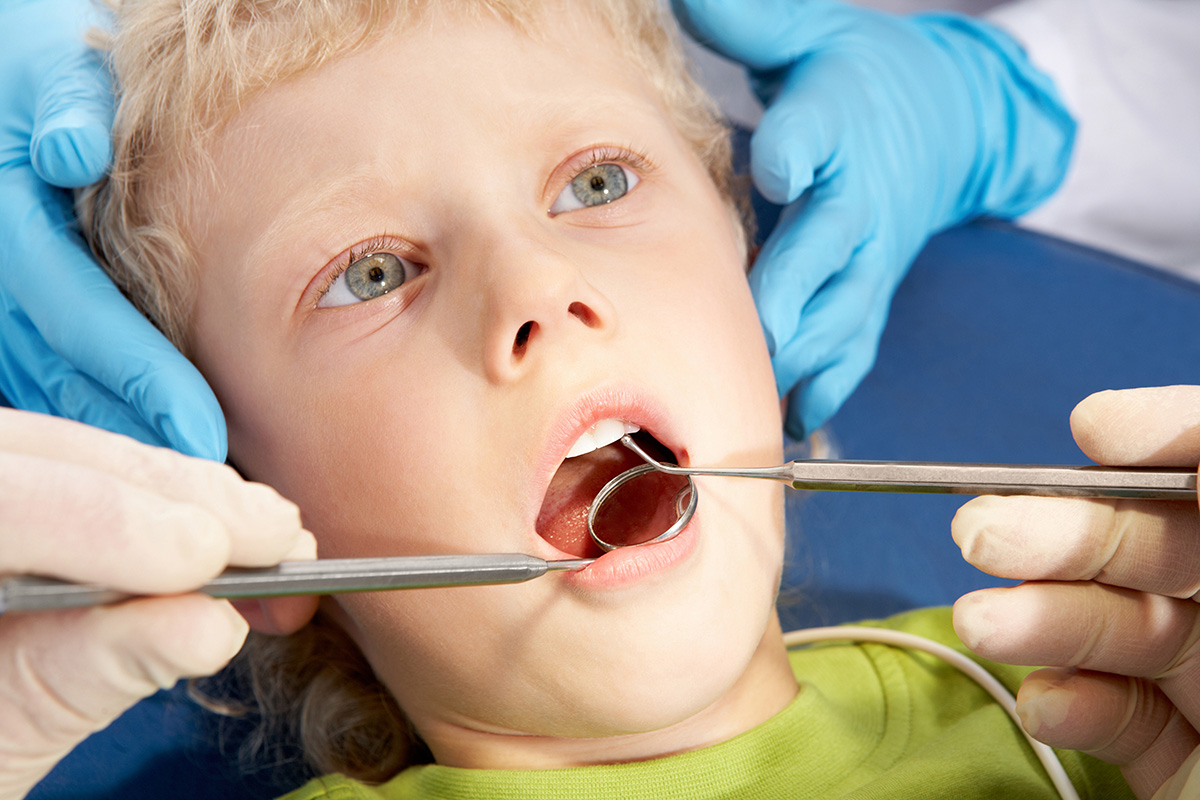 young boy visiting a pediatric dentist