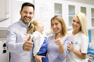 a family poses at their family dentistry