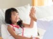 child and parent high-fiving after finding a pediatric dental office