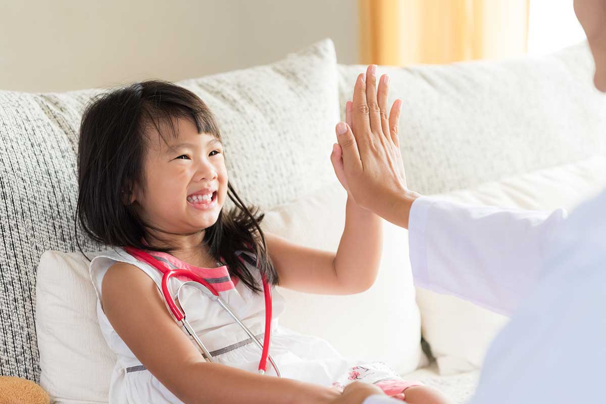 child and parent high-fiving after finding a pediatric dental office