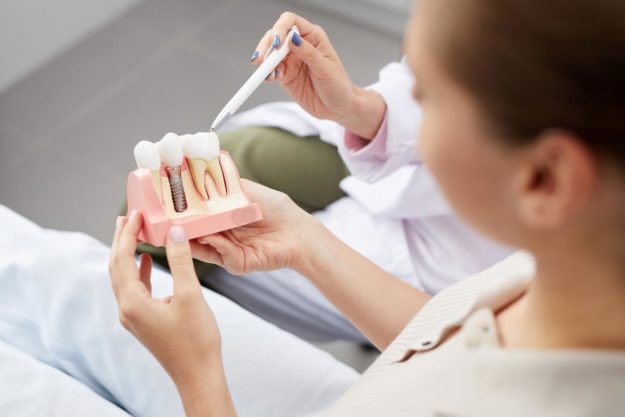 4 Benefits of Dental Implants woman considers dental implants